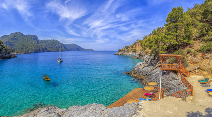 Secluded waterfront deck overlooking a clear Mediterranean bay