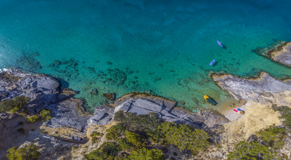 Aerial View of a Rocky Mediterranean Cove with Clear Turquoise Water