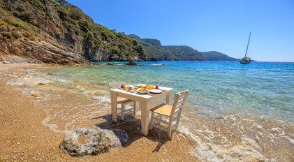 Private chef beachfront breakfast on a secluded Mediterranean shoreline