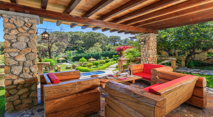Private chef garden veranda dining in a rustic stone-and-wood setting