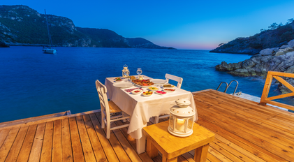 Private chef waterfront dining setup on a quiet Mediterranean sea deck
