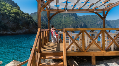 Private chef seaside deck dining overlooking a turquoise Mediterranean bay