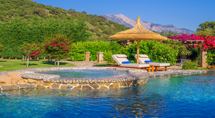 Secluded garden jacuzzi and pool terrace framed by Mediterranean greenery