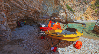 Recreation equipment station set within a sheltered rocky cove on the Mediterranean coast