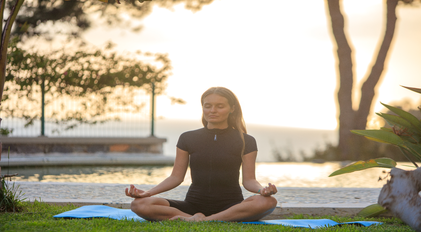 Sunset meditation beside a calm pool overlooking the quiet Mediterranean