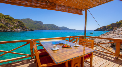Mindful seaside coffee break overlooking turquoise Mediterranean bay