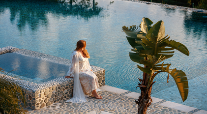 Calm wellness moment by a stone-edged pool on a secluded peninsula