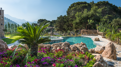 Lush landscaped garden and stone-designed pool at Villa Elmalı