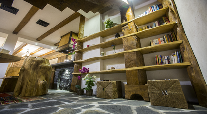 Handcrafted wooden shelving integrated into a rustic Mediterranean interior