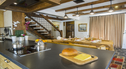 Warm interior kitchen and dining space with handcrafted wooden details