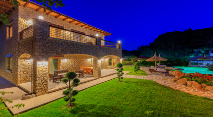 Night-lit stone architecture and garden pathway at Villa Elmalı