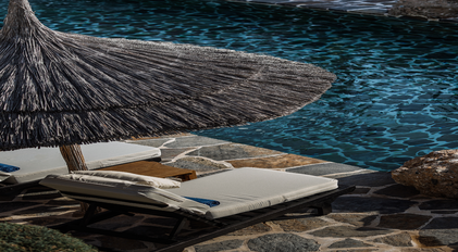 Poolside sunlounger and shaded umbrella detail at Villa Elmalı