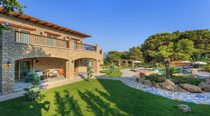 Stone villa surrounded by landscaped gardens and a secluded pool terrace
