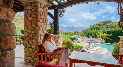 Terrace seating area with pool and mountain view at Villa Gemile
