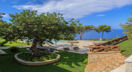 Garden terrace overlooking infinity pool and Aegean blue horizon