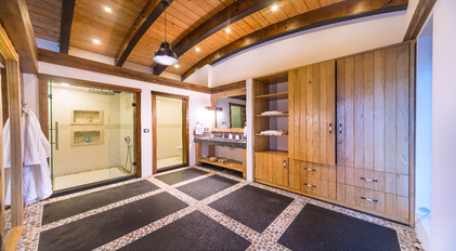 Spacious master bathroom with double shower and wooden cabinetry