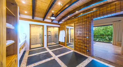 Spacious master bathroom with double walk-in showers and wooden vaulted ceiling