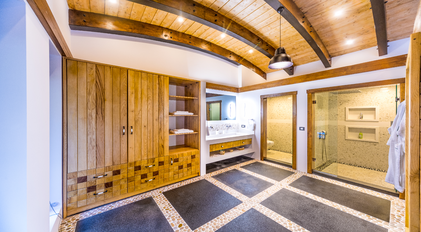 Master bathroom with vaulted wooden ceiling and double walk-in showers