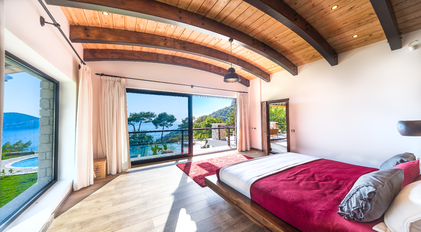 Master bedroom with panoramic sea view and arched timber ceiling