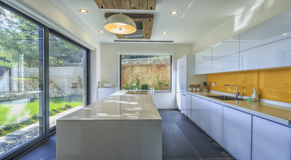 Bright modern kitchen with island counter and large garden-facing windows
