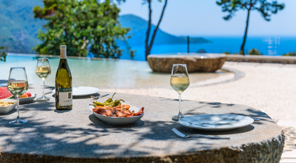 Seafood lunch setting beside the infinity edge with Mediterranean views