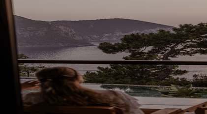 Terrace viewpoint overlooking a secluded Mediterranean bay at dusk
