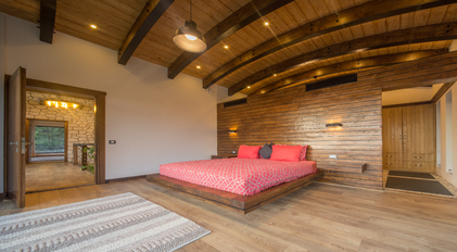 Warm wooden bedroom with arched beams and soft natural Mediterranean light