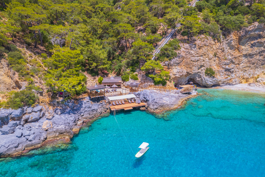 Aerial Perspective of a Secluded Mediterranean Waterfront Deck and Forest