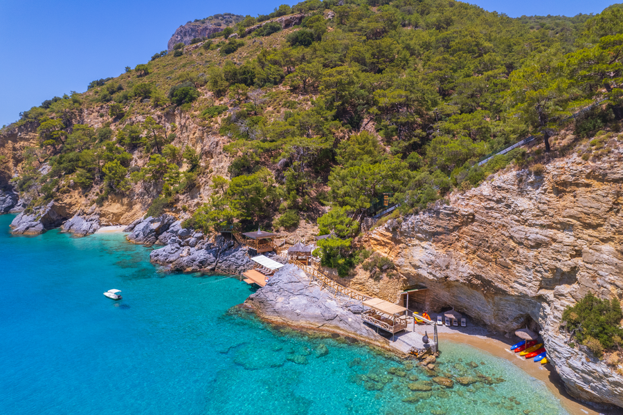 Aerial View of Secluded Bay, Cliffside Terraces and Forested Mediterranean Peninsula