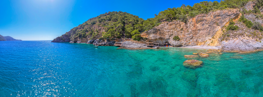 Wide Aerial View of Mediterranean Bay and Forested Peninsula Coastline
