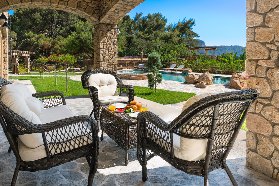 Poolside terrace light dining prepared by a private chef in a stone-arch villa setting