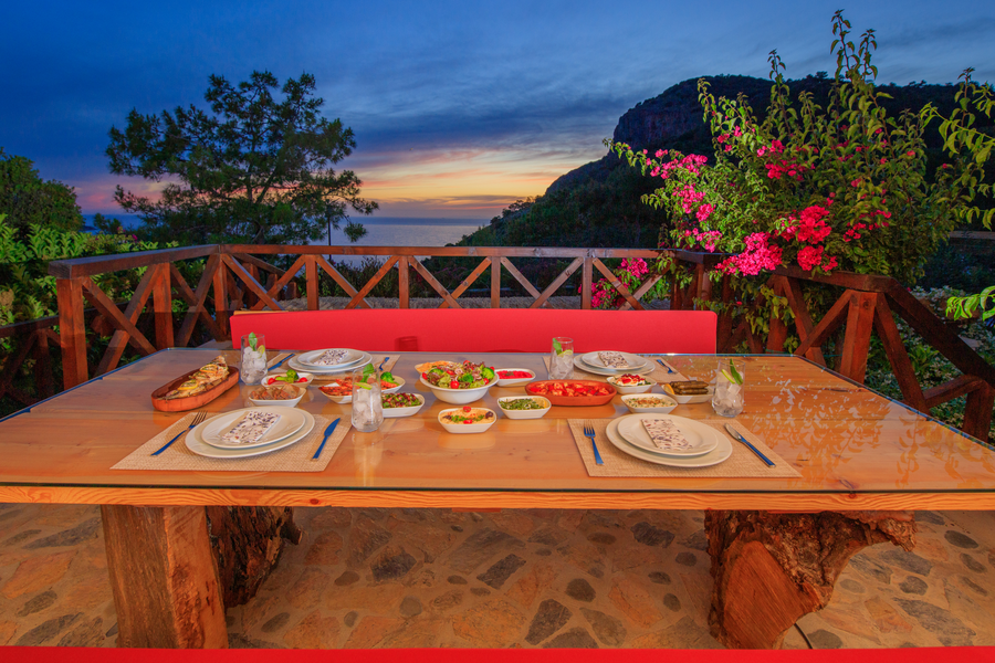 Private chef sunset dining on a forest veranda overlooking the Mediterranean