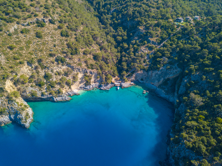 Aerial view of a secluded private bay on a forested peninsula