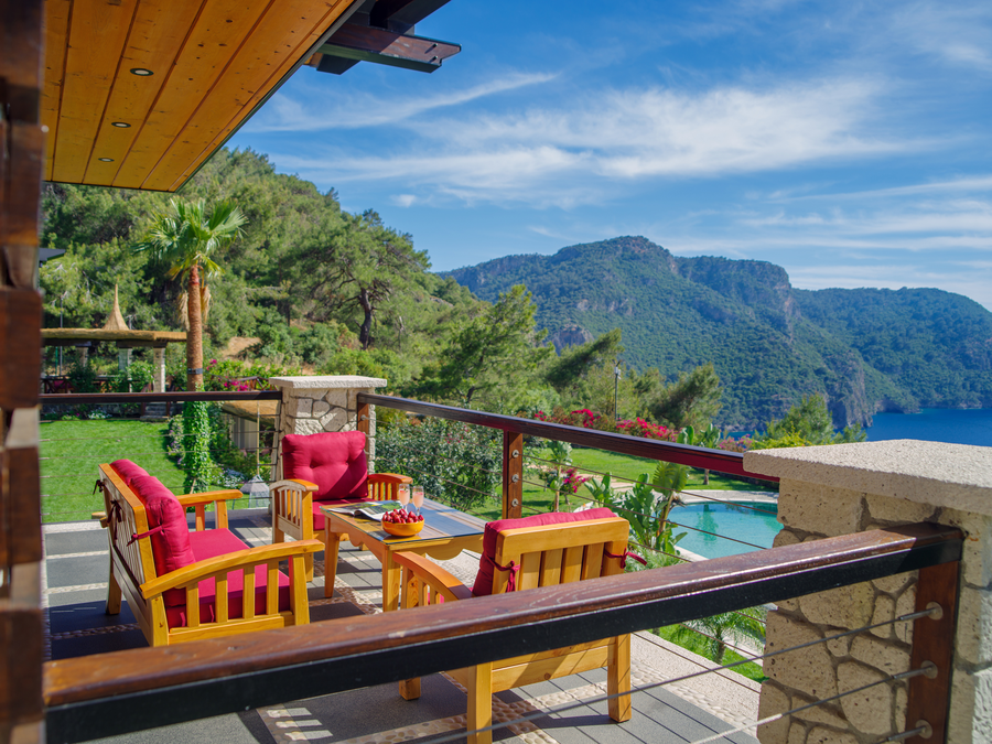 Secluded hillside terrace overlooking the Mediterranean and lush gardens