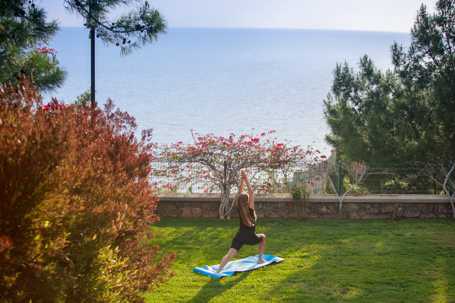 Morning yoga practice in a quiet garden overlooking the open Mediterranean