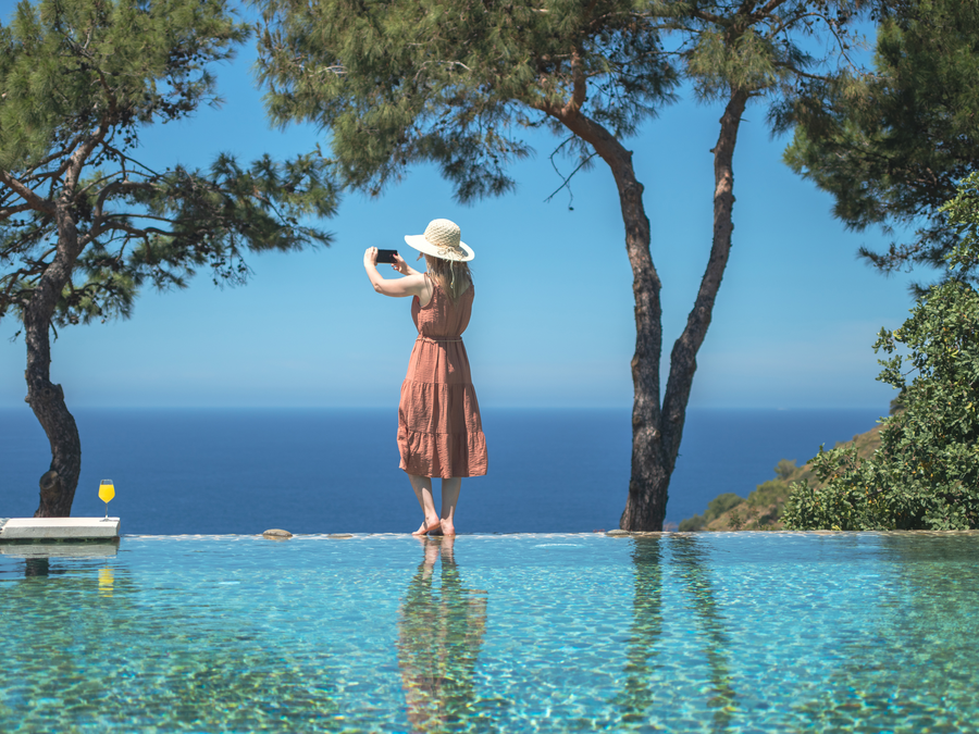 Mindful wellness moment at an infinity pool overlooking the deep-blue Mediterranean