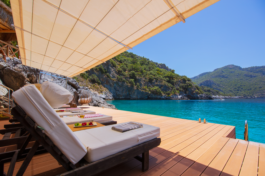 Serene seaside wellness sundeck above turquoise Mediterranean waters