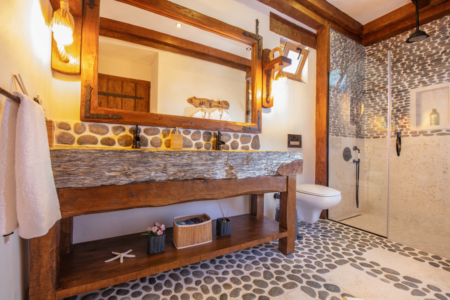 Rustic bathroom with stone basin, natural wood accents and pebble textures