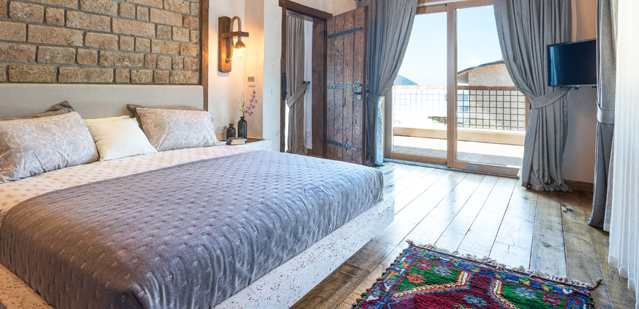 Master bedroom bed detail with terrace and sea-view access