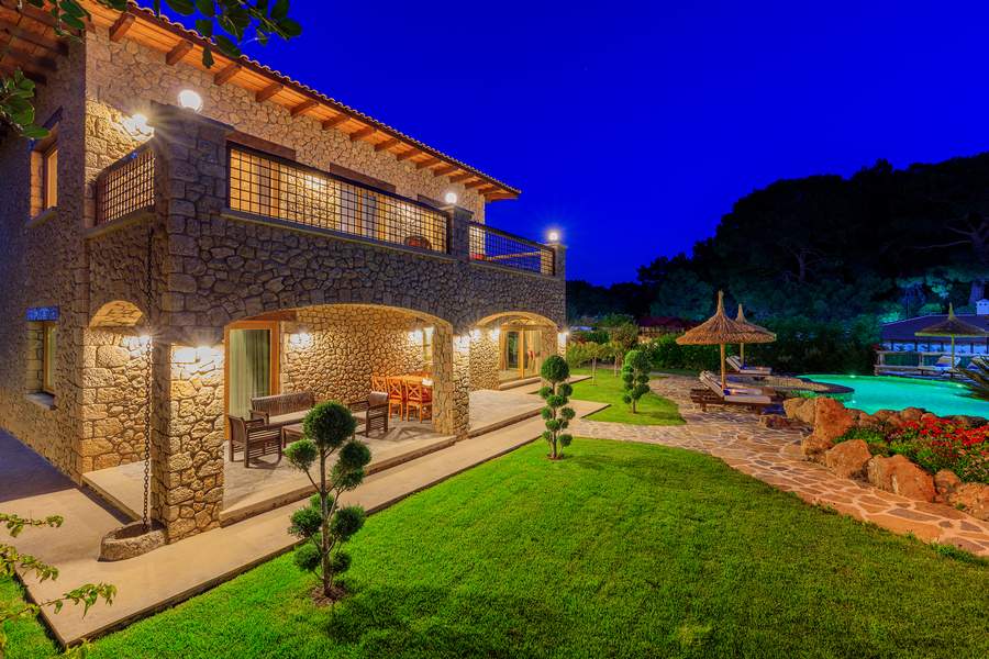 Night-lit stone architecture and garden pathway at Villa Elmalı