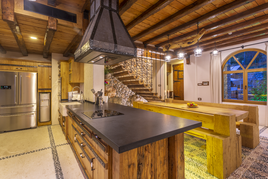 Rustic kitchen and dining space with stone staircase and handcrafted wood details