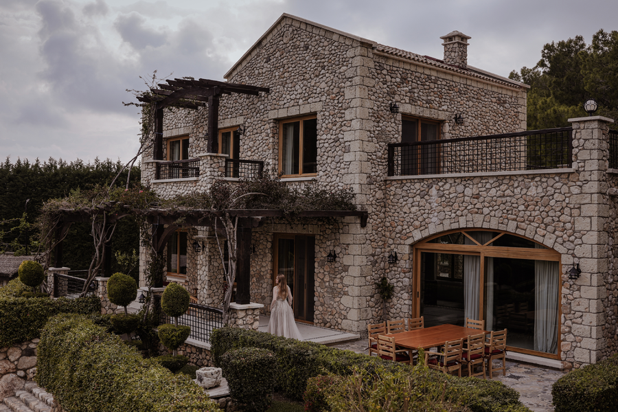 Stone villa façade with terraces and Mediterranean garden landscaping