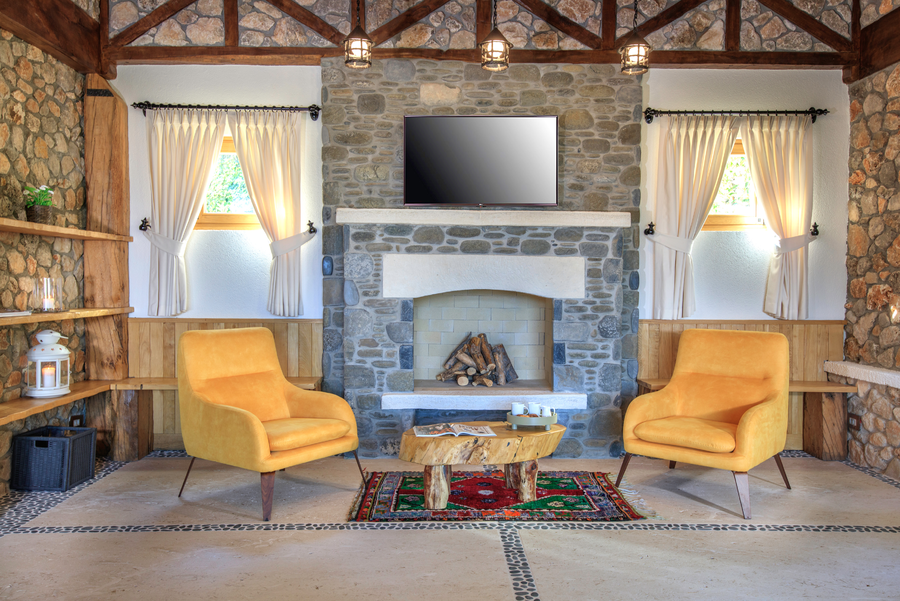 Stone fireplace lounge with armchairs and handcrafted wood table