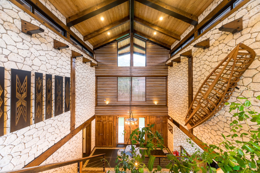 Grand entrance hall with rustic stone walls and vaulted wooden ceiling