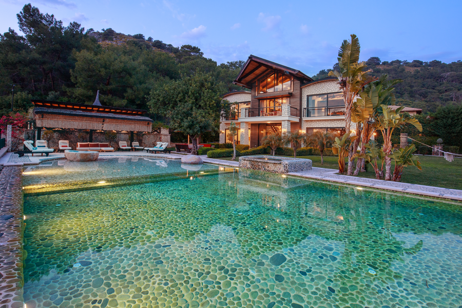 Natural-stone pool and main villa overlooking a secluded Mediterranean landscape