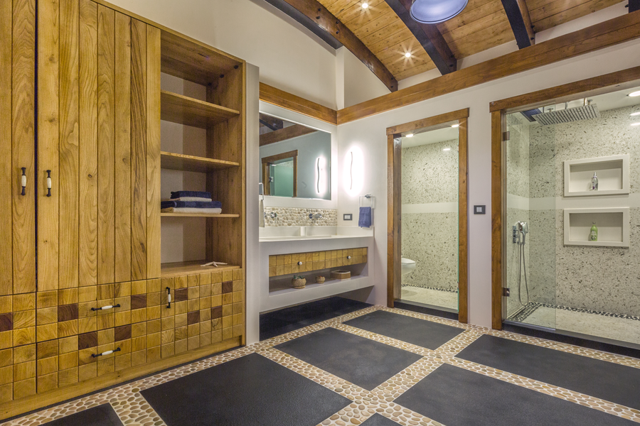 Master bathroom with wood cabinetry and walk-in stone shower