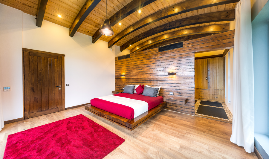 Master bedroom with wooden accent wall and platform bed