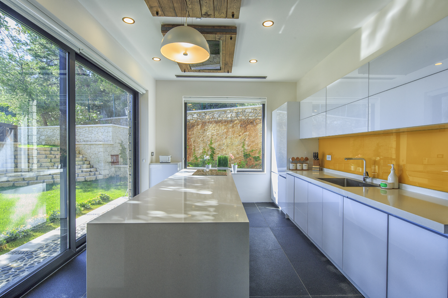 Bright modern kitchen with island counter and large garden-facing windows