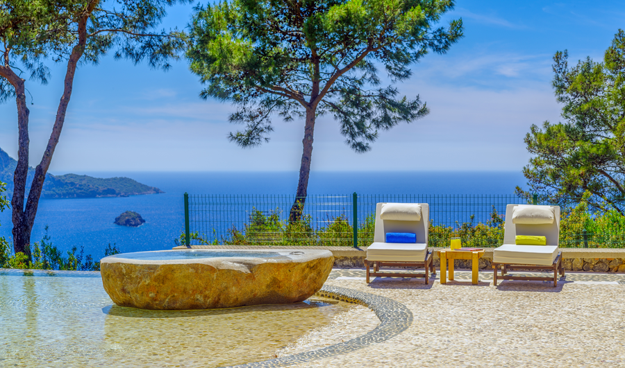 Terrace loungers and stone jacuzzi overlooking the Mediterranean sea